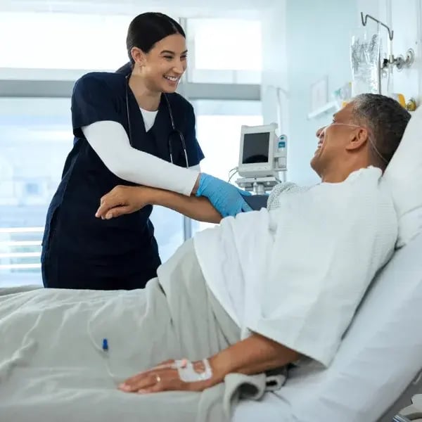 A doctor measuring a patient's blood pressure in a hospital room