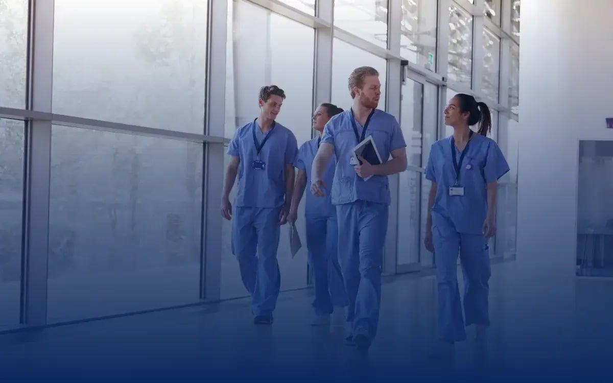 A group of doctors walking in a hospital aisle