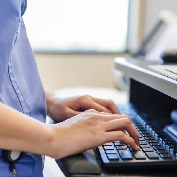 Nurse hands typing on a keyboard