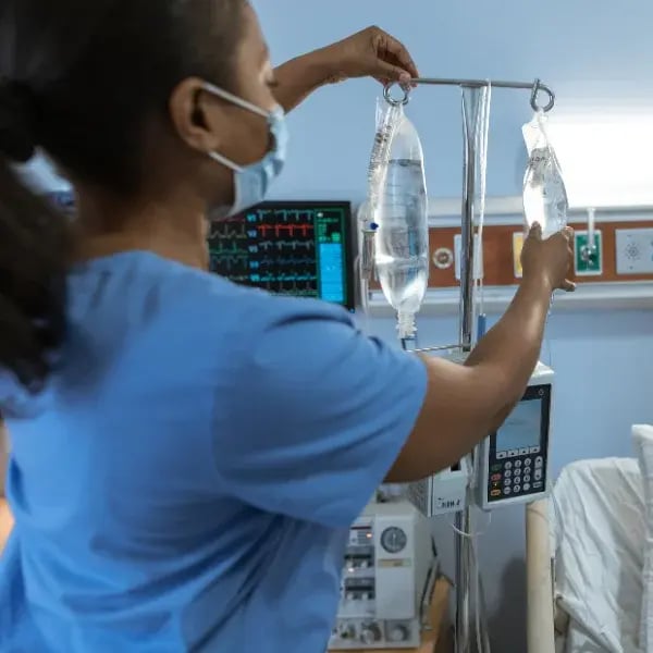 Nurse adjusting IV bag