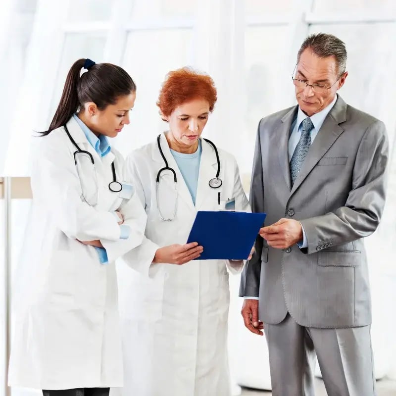 A group of healthcare professionals collaborate in a hospital setting.