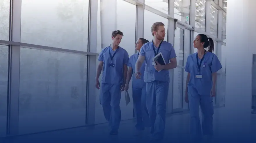 A group of doctors walking in a hospital aisle