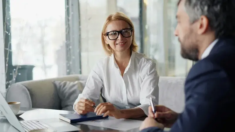 A woman and a man talking in an office