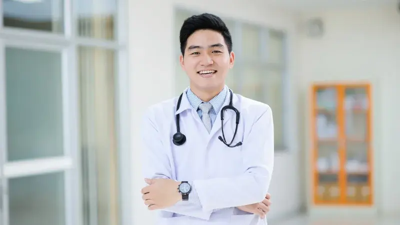 Asian male doctor smiling to the camera in a hospital